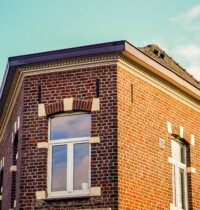 A low angle shot of an apartment building under the sunlight at daytime